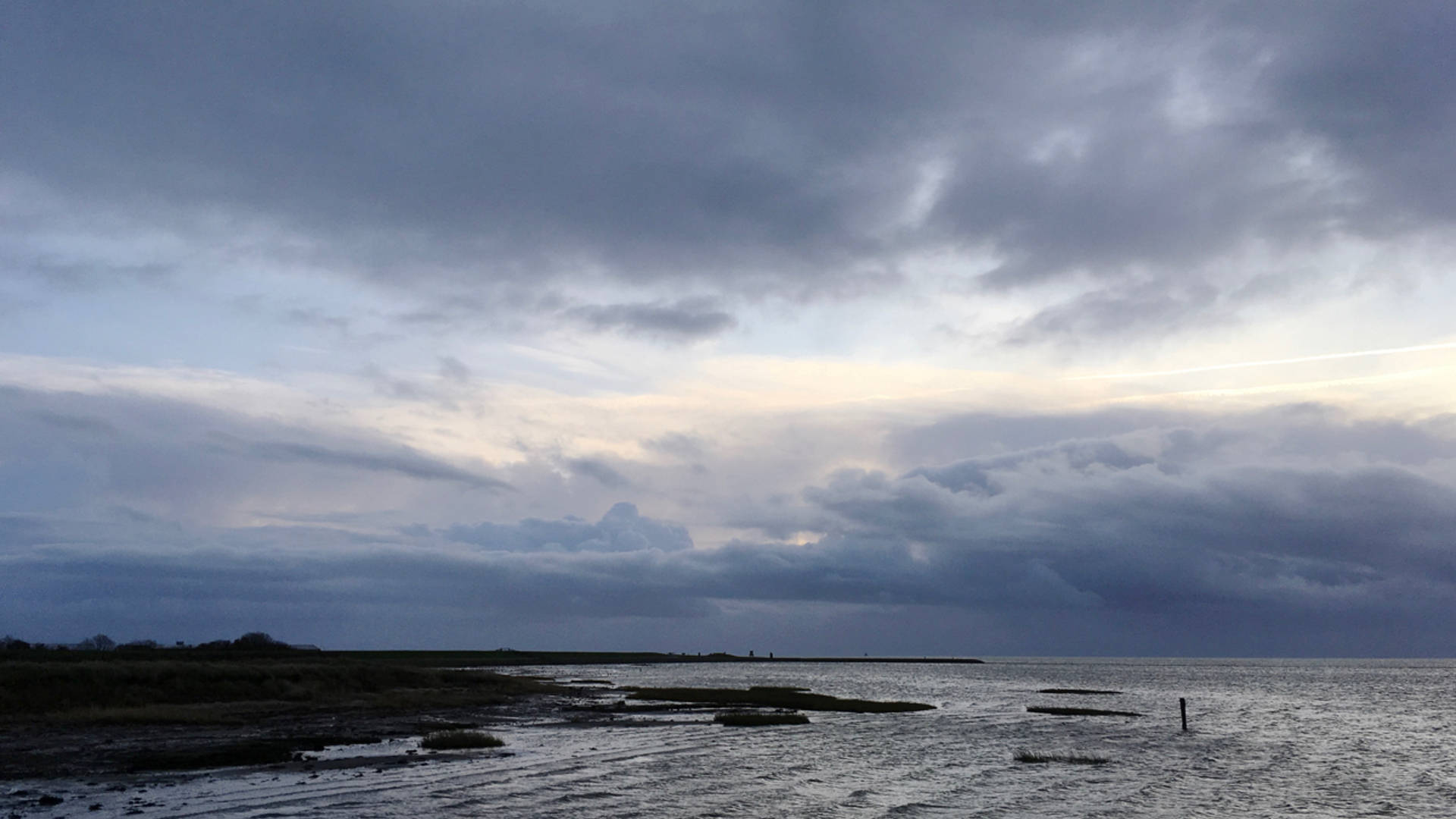 Donkere wolken boven de wadden